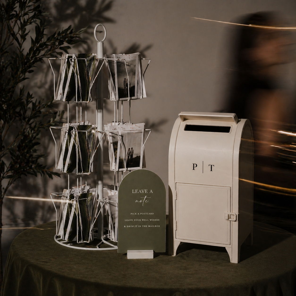 Decorative stand with cards and a mailbox on a table against a dark background
