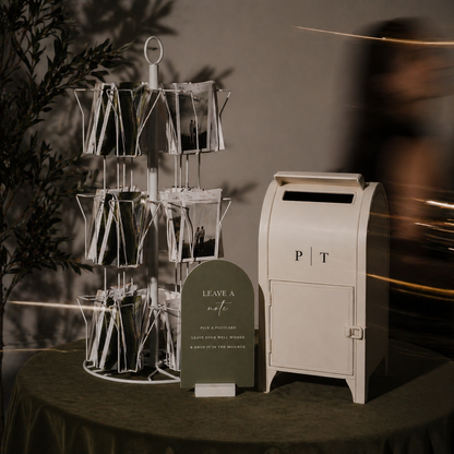 Decorative stand with cards and a mailbox on a table against a dark background