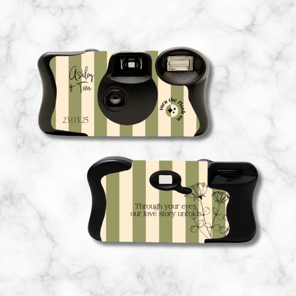 Two camera cases with striped design and text on a marble background